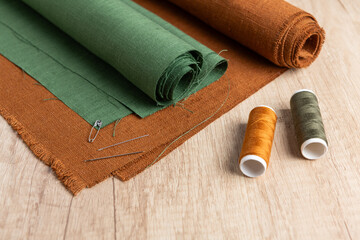 Fototapeta na wymiar Sewing studio, linen rolls, threads and needles