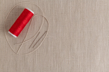 Simple sewing background, threads with needles on linen fabric - 733417365