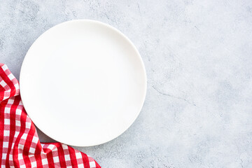 White plate and napkin at stone table. Table setting, Flat lay image.