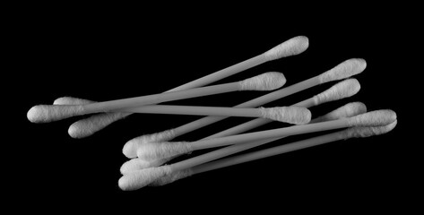 Group cotton swab, bud for ear cleaning, hygiene product isolated on black background