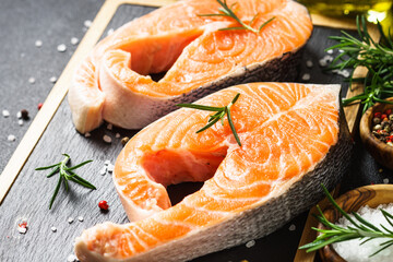 Fresh steaks on cutting board with spices. Close up.