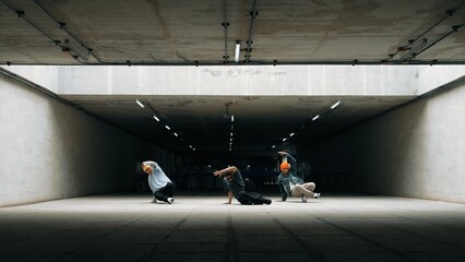 Panorama shot of hipster group dance together while perform b-boy dance. Street dancer team moving...