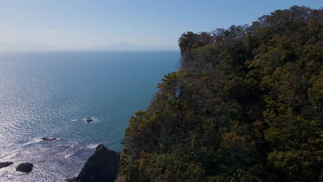 Cinematic aerial shot of lighthouse at Cape Chikyu in Muroran City in Hokkaido, Japan