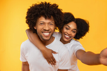 Portrait of beautiful happy african american couple taking selfie