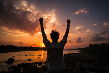 Fototapeta premium Silhouette of a happy man with his hands raised up against the backdrop of a sunset or dawn. Generated by artificial intelligence