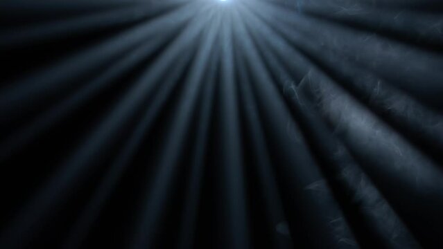 Studio shot of projector haze isolated on black background. Close up of blue light rays shining from top with smoke motion.