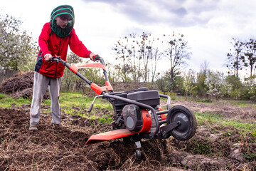 Motoblock in the field of the household. Work with a motor cultivator, plowing the soil for sowing...