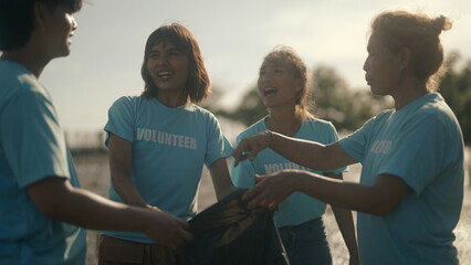 Group of volunteers cleaning on the beach