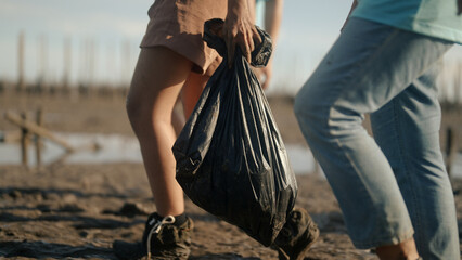 Group of volunteers cleaning on the beach - 733446772