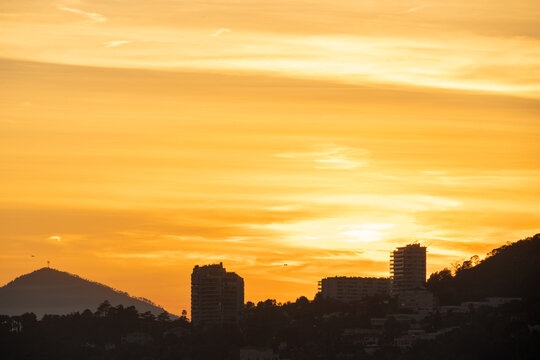 A city in the mountains at sunset, high building. High quality photo