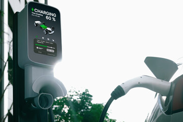 EV electric car charging in green sustainable city outdoor garden in summer. Urban sustainability lifestyle by green clean rechargeable energy of electric BEV vehicle innards - obrazy, fototapety, plakaty