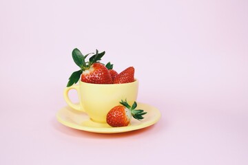 strawberries in a yellow cup