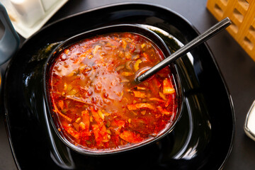 National dish of Russian cuisine is Solyanka soup, served with sour cream