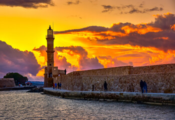 Fototapeta premium Chania with the amazing lighthouse, mosque, venetian shipyards, at sunset, Crete, Greece.