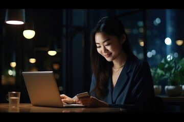 Young happy asian business woman at work