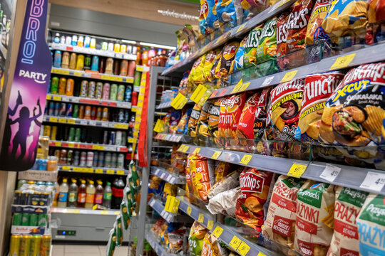 Convenience store alley with chips crisps party snacks and energy drinks, interior detail, inside a small shop, various brands, Crunchips, Lays, party food supplies