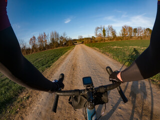 Riding a gravel bike on a rural countryside path rider point of view