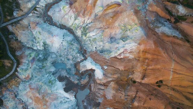 Cinematic aerial shot of geothermal steam vents in Jigokudani Hell Valley in Noboribetsu city in Hokkaido, Japan