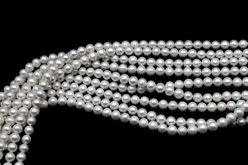 Beautiful and round Chinese freshwater pearls on a black background, ready to be made into...