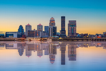 Beautiful sunset night view of Louisville Kentucky Skyline with river, bridge and lit buildings - 733459746