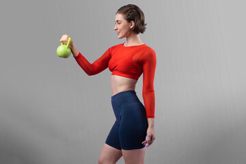 Full body length gaiety shot athletic and sporty woman with kettlebell for weight lifting as...