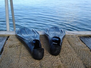 Flippers on the pier, ready for swimming and diving