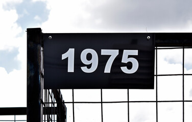 Street sign number 1975 on a black grid