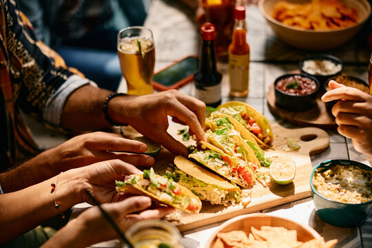 Close up of people eating Mexican food in restaurant.