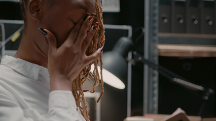 Federal investigator reading confidential report in arhive room, working on crime case. Private...