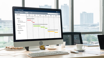 Project planning software for modish business project management on the computer screen showing timeline chart of the team project