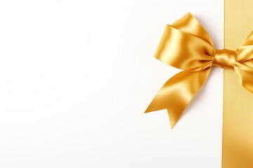 Ribbon and bow of shiny gold satin on white background. Copy space. Gold satin gift bow ribbon. A luxurious gold satin ribbon tied in a perfect bow. Valentine's day, Mother's day, Women's Day, Wedding