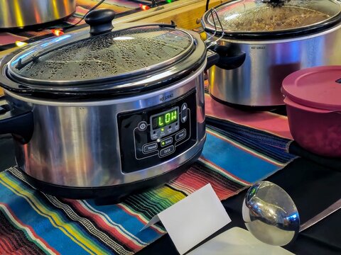 Crockpots on colorful striped cloth for chili cookoff