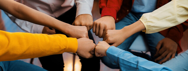 Startup company employee team stacking hand together symbolize successful group of business partnership and strong collective unity teamwork in community workplace in panoramic banner. Synergic