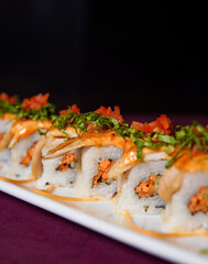 Red Dragon Roll served on a black wooden plate, avocado, cucumber, lump crab meat, sushi menu, social media post, food photography, fine dining, Japanese food, purple background