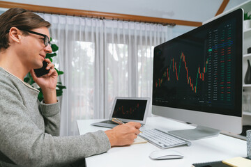 Working smart stock investors calling to broker to select interesting market stock exchange on pc...