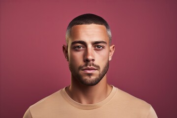 Portrait of a handsome young man. Studio shot over pink background.