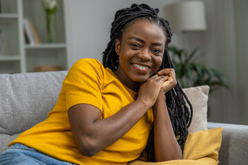 Cute african american woman in yellow tshirt smiling nicely