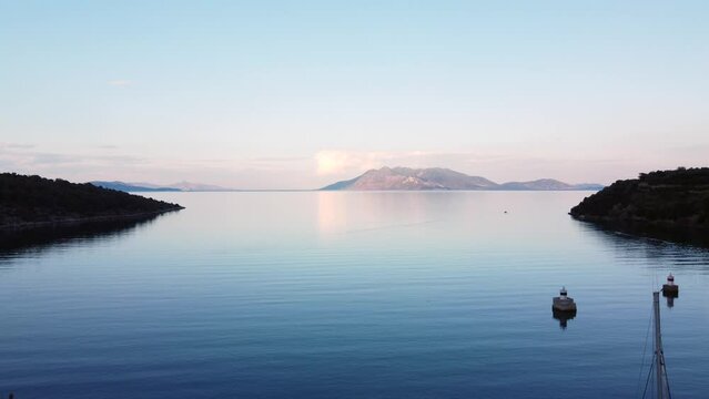 This footage was made with a drone, near the Ancient Epidaurus town during sunset, with the sea, sailboats and the town in the frame