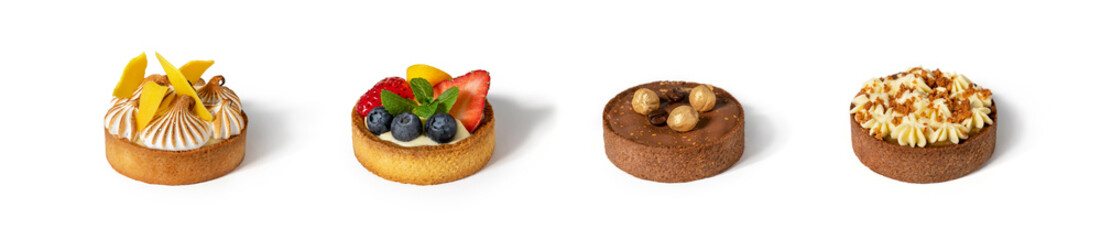 Set of tartlets with whipped cream, berries, chocolate and nuts on white background. Candy bar,...