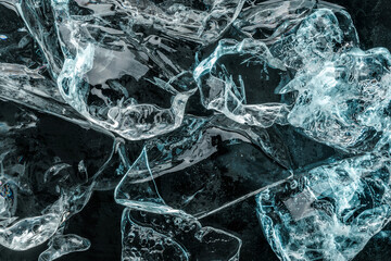 Pieces of crushed ice on dark blue background. Abstract ice structure background, top view
