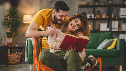 man and woman caucasian adult couple read book at home