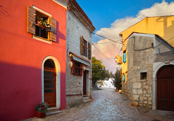 Rovinj, Istria, Croatia. Vintage stone street with old colorful houses during evening sunset. Picturesque little town in Europe. Popular travel destination and resort.