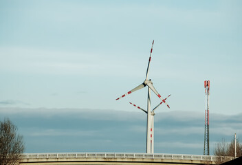 Wind farm park next to a road in Austria in sunny weather.
