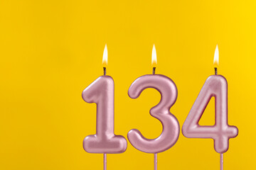 Birthday candle number 134 - Birthday celebration on yellow background