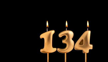 Golden candle 134 with flame - Birthday card on dark luxury background
