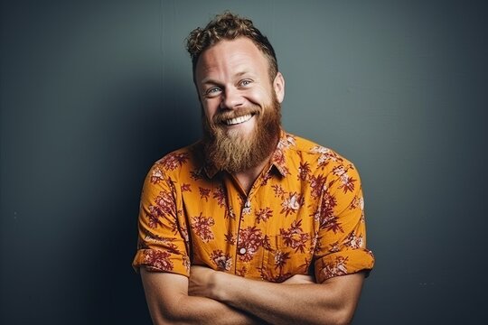 Portrait of a handsome young man with long red beard and mustache