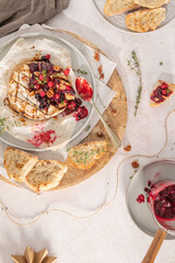 Baked or fried grilled Camembert or brie cheese with berry sauce or jam. Gourmet traditional Breakfast close up.