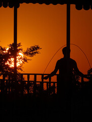 silhouette of a person at sunset