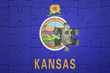 puzzle with the national flag of kansas state and usa dollar banknote. finance concept