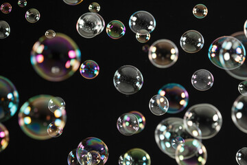 Glowing soap bubbles on black background.